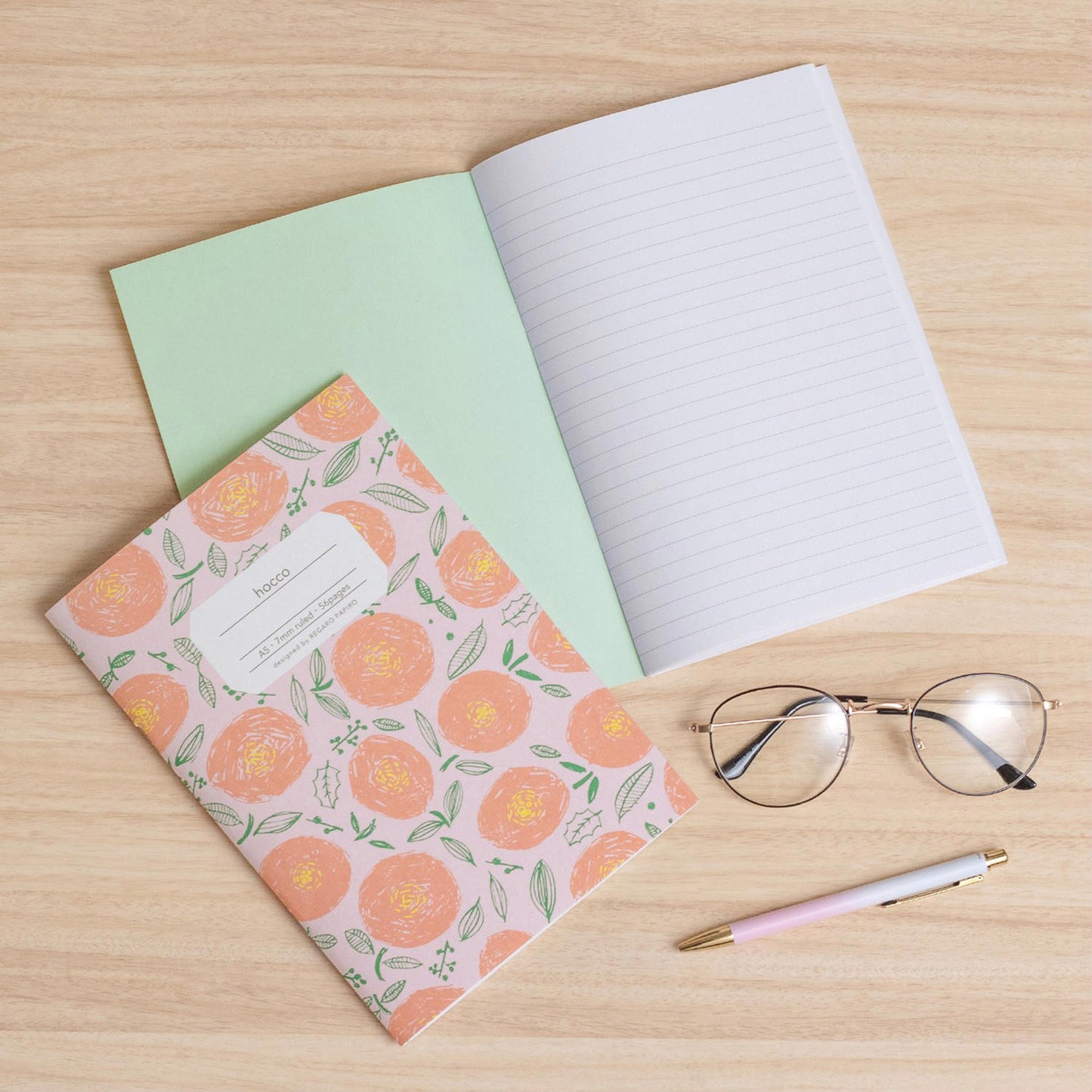 notebook florar shaped open notebook lined glasses and pink pen